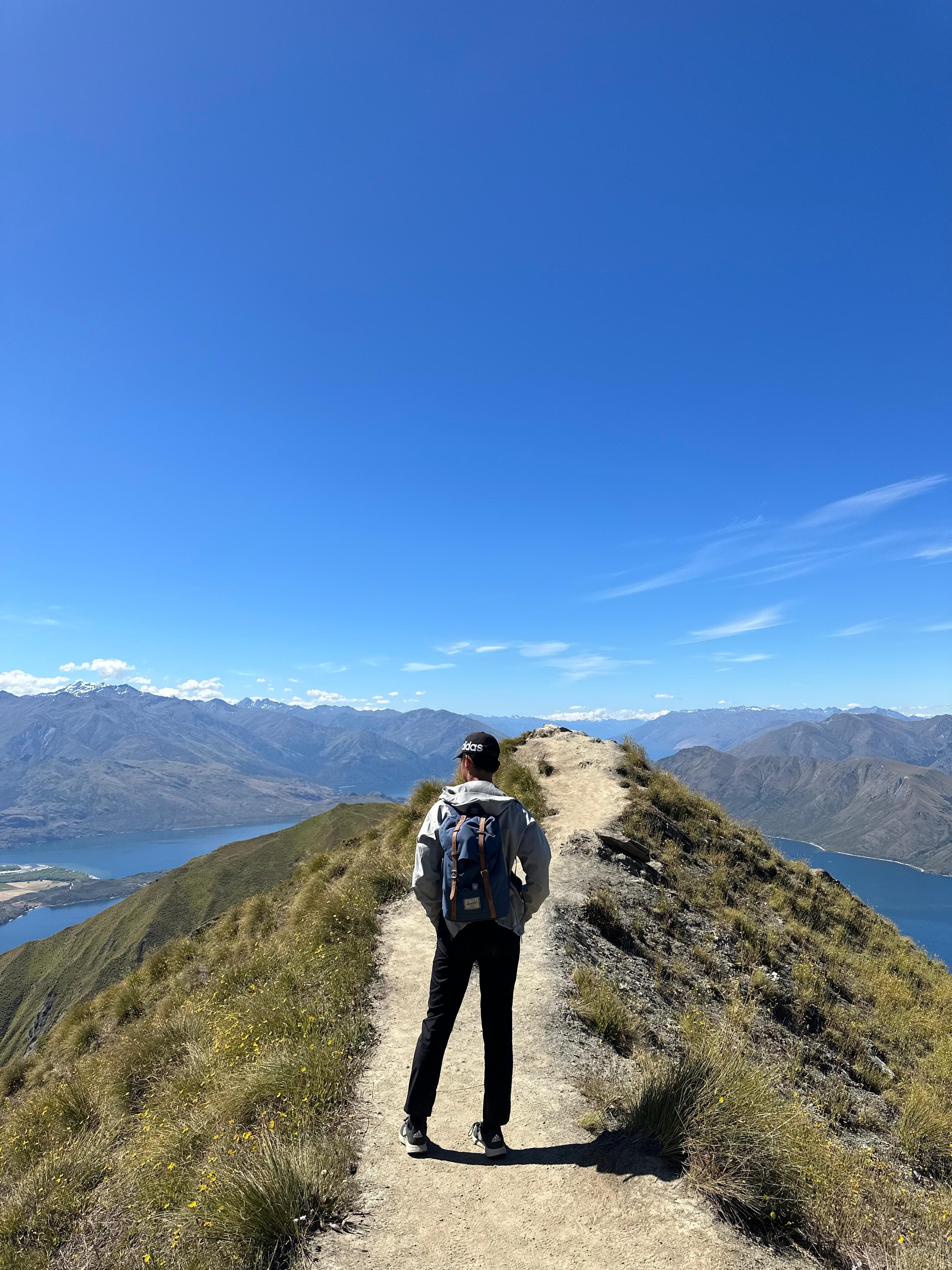 Hiking a mountain ridge trail above a lake